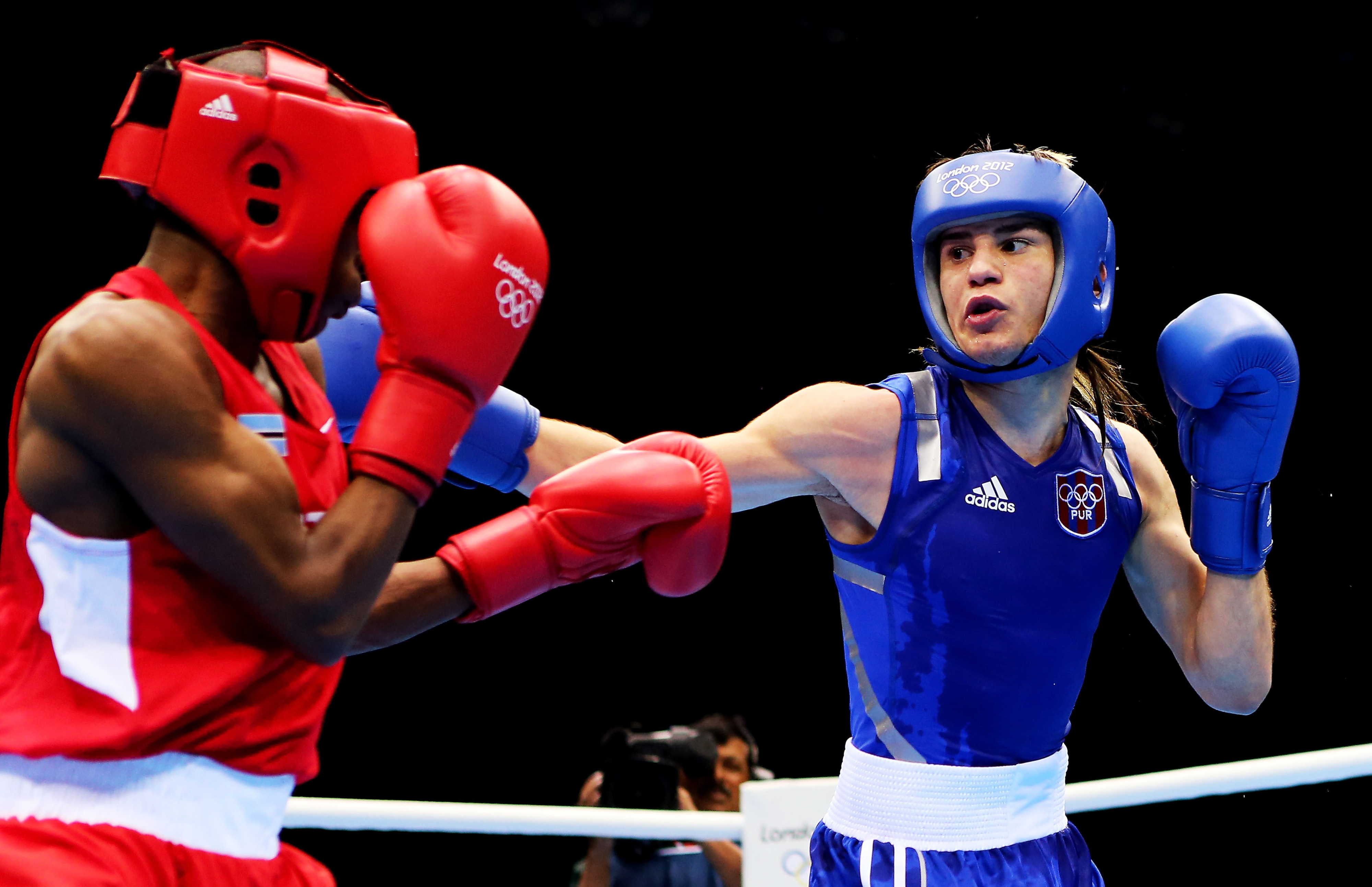 Jeyvier Cintron (seen here in the round of 32) of Puerto Rico got past Brazil's Juliao Henriques this morning in London, advancing to the flyweight quarterfinals. (Photo by Scott Heavey/Getty Images)