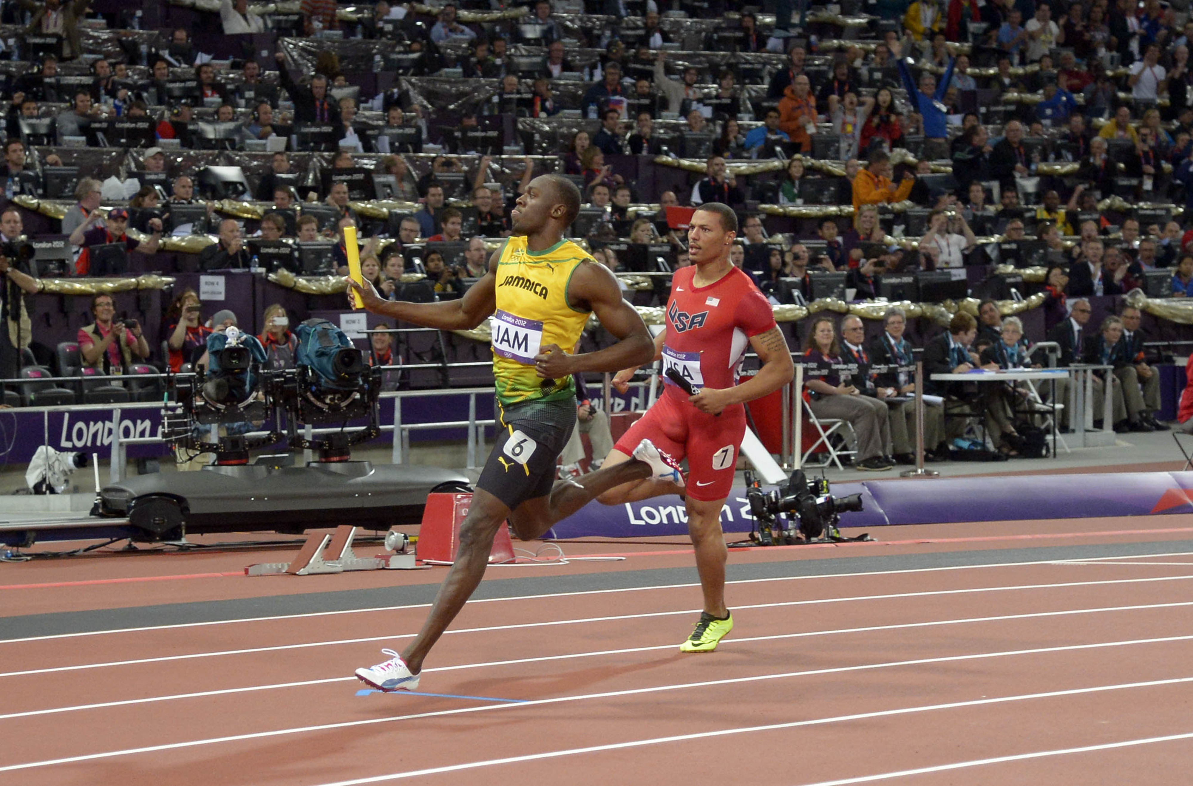 Aug 11, 2012; London, United Kingdom; Usain Bolt  reacts after running the anchor leg on the Jamaica 4 x 100m relay that set a world record of 36.84 in the London 2012 Olympic Games at Olympic Stadium.Mandatory Credit: Kirby Lee-USA TODAY Sports