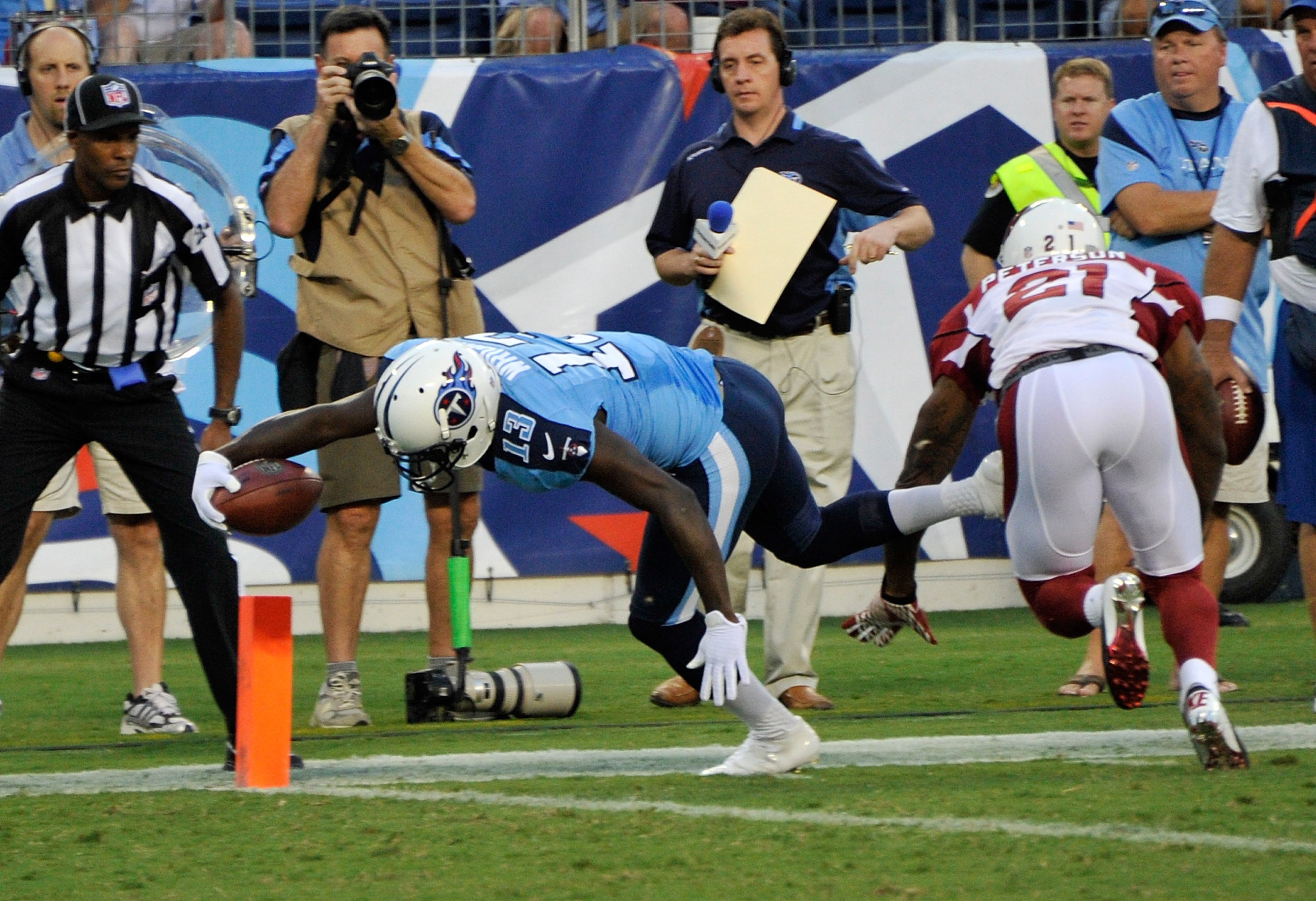 NASHVILLE, TN - AUGUST 23:  Kendall Wright #13 of the Tennessee Titans dives past Patrick Peterson #21 of the Arizona Cardinals for a touchdown at LP Field on August 23, 2012 in Nashville, Tennessee.  (Photo by Frederick Breedon/Getty Images)