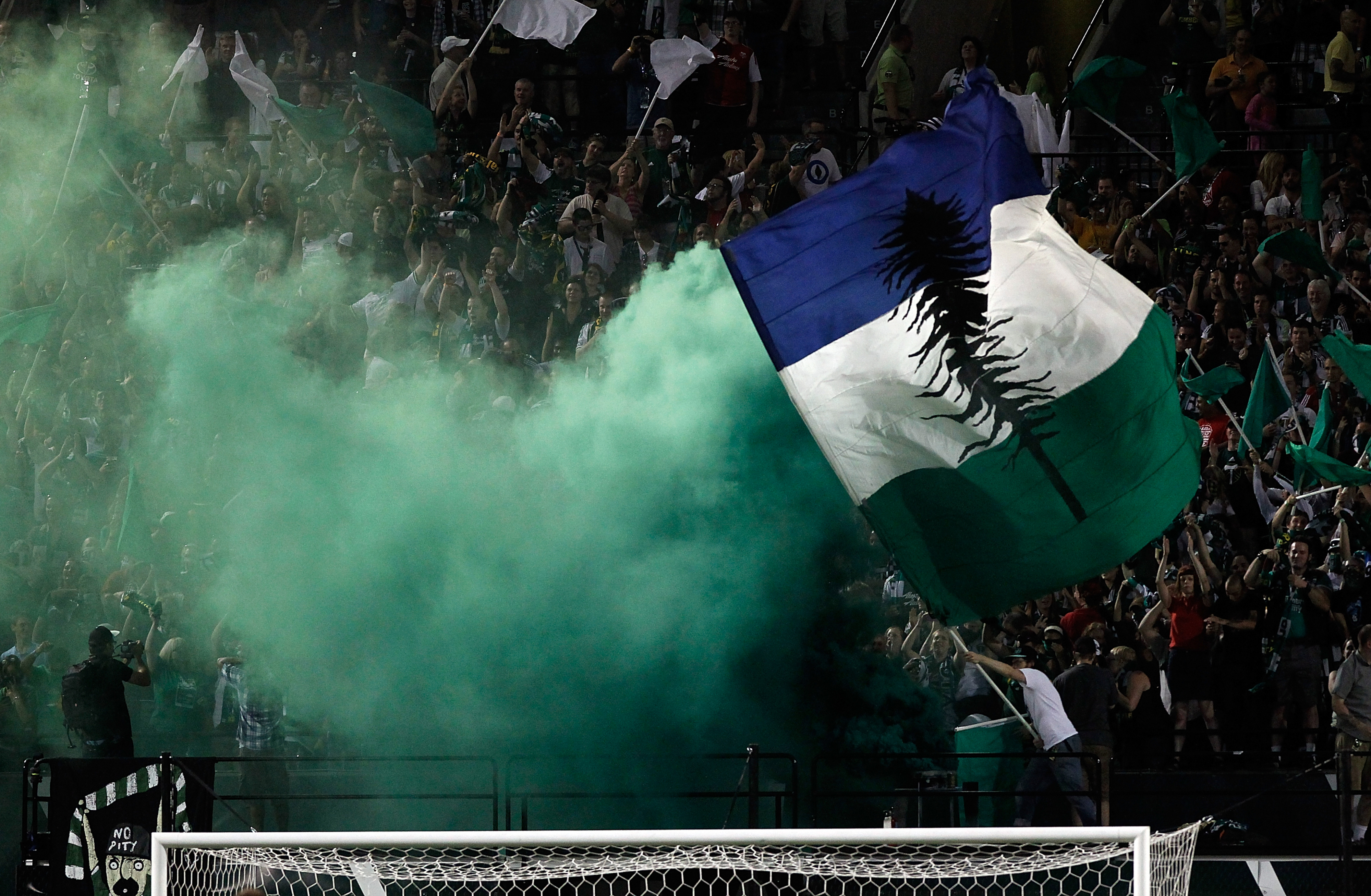 PORTLAND, OR - AUGUST 25: Fans of the Portland Timbers celebrate a goal against the Vancouver Whitecaps on August 25, 2012 at Jeld-Wen Field in Portland, Oregon. (Photo by Jonathan Ferrey/Getty Images)