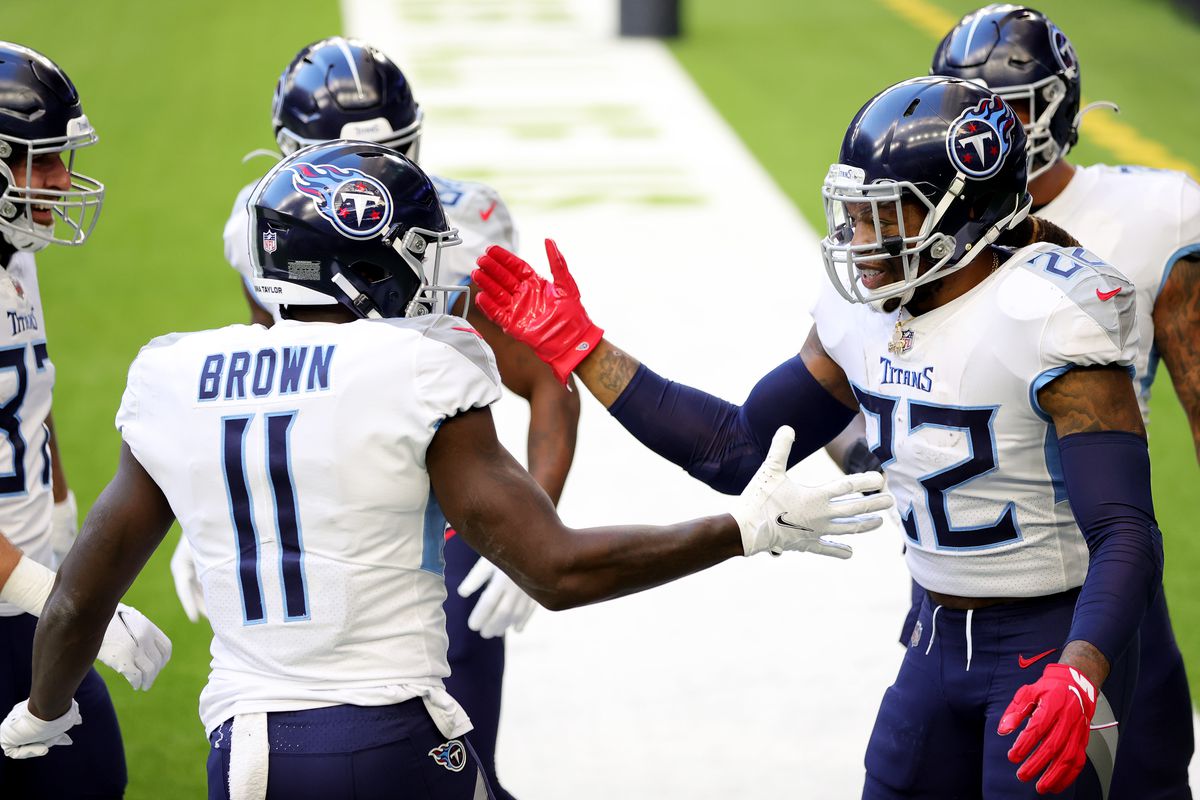 Derrick Henry #22 and A.J. Brown #11 of the Tennessee Titans in action against the Houston Texans during a game at NRG Stadium on January 03, 2021 in Houston, Texas.