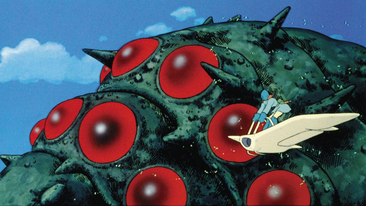 An anime woman in a blue outfit pilots a flying glider alongside a gigantic red-eyed insect creature