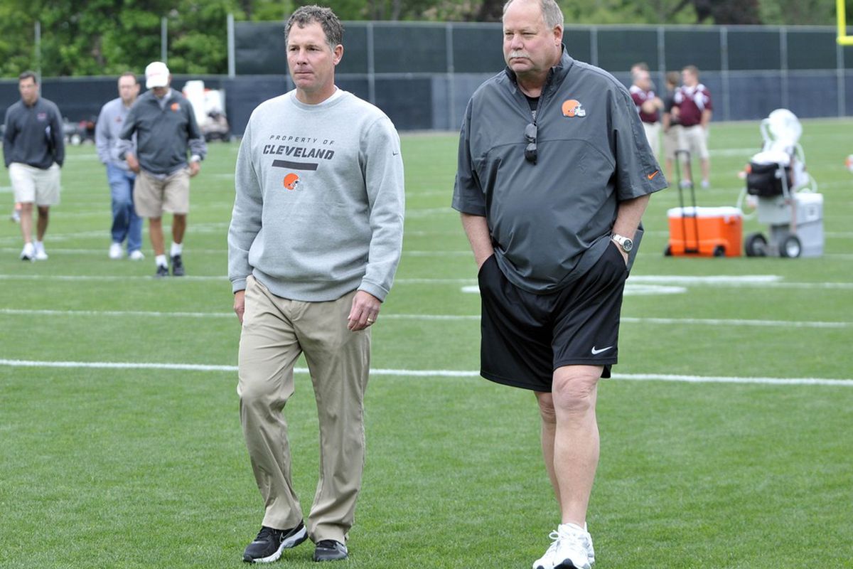 Jun 5, 2012; Berea, OH, USA; Cleveland Browns head coach Pat Shurmur (left) walks with team president Mike Holmgren during minicamp at the Cleveland Browns training facility. Mandatory Credit: David Richard-US PRESSWIRE