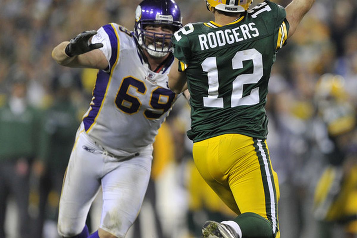 GREEN BAY WI - OCTOBER 24:  Jared Allen #69 of the Minnesota Vikings pressures Aaron Rodgers #12 of the Green Bay Packers at Lambeau Field on October 24 2010 in Green Bay Wisconsin. (Photo by Jim Prisching/Getty Images)
