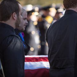 The casket of West Valley police officer Cody Brotherson is carried to the graveside service at Valley View Memorial Park in West Valley City on Monday, Nov. 14, 2016.