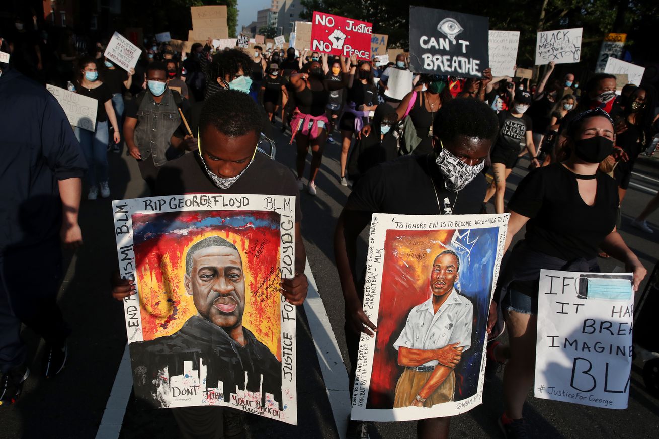 Demonstrators marching on the street in a Justice For Black Lives protest