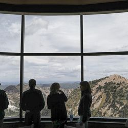 People take in the view from the restaurant at the top of Snowbird as members of two legislative bodies tour areas of Snowbird and Solitude to learn more about the proposed federal designation by Wasatch Canyons Commission on Monday, Sept. 16, 2019.