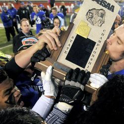 Bingham's Dalton Schultz kisses the championship trophy following the presentation ceremony during the 5A state championships at Rice-Eccles Stadium on Nov. 22, 2013.