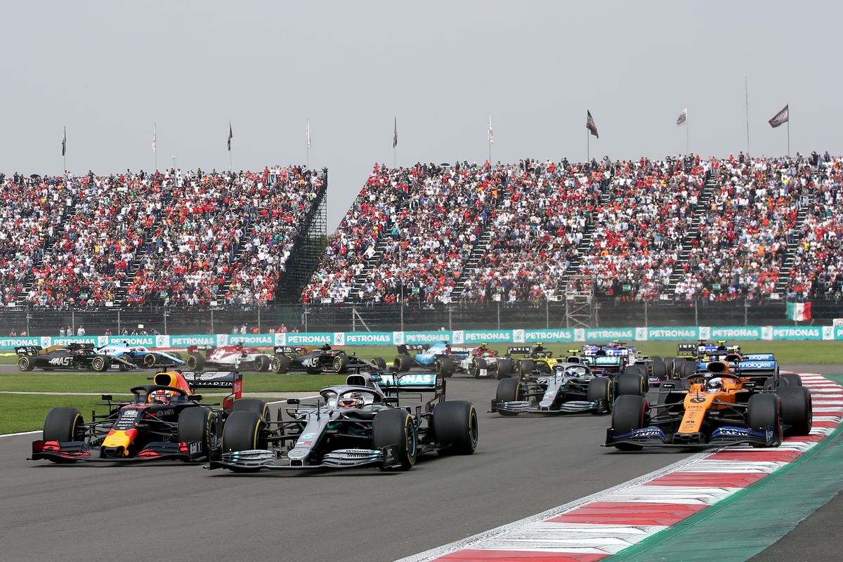 Max Verstappen of the Netherlands driving the (33) Aston Martin Red Bull Racing RB15, Lewis Hamilton of Great Britain driving the (44) Mercedes AMG Petronas F1 Team Mercedes W10 and Carlos Sainz of Spain driving the (55) McLaren F1 Team MCL34 Renault battle for position at the start during the F1 Grand Prix of Mexico at Autodromo Hermanos Rodriguez on October 27, 2019 in Mexico City, Mexico.