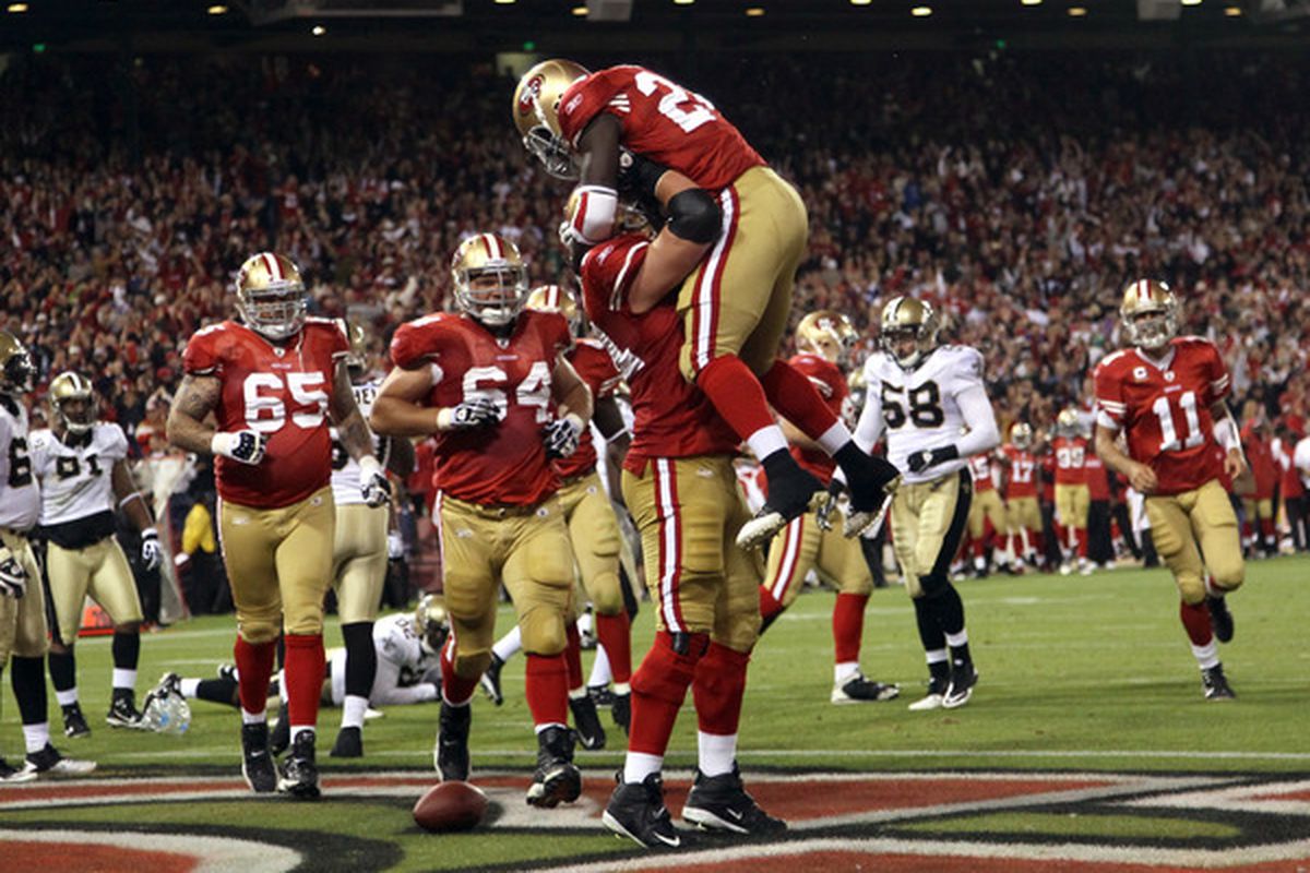 Here we see Joe Staley lifting and threatening Anthony Dixon, telling him that if he does not stop dancing, he will face the consequences.   (Photo by Ezra Shaw/Getty Images)
