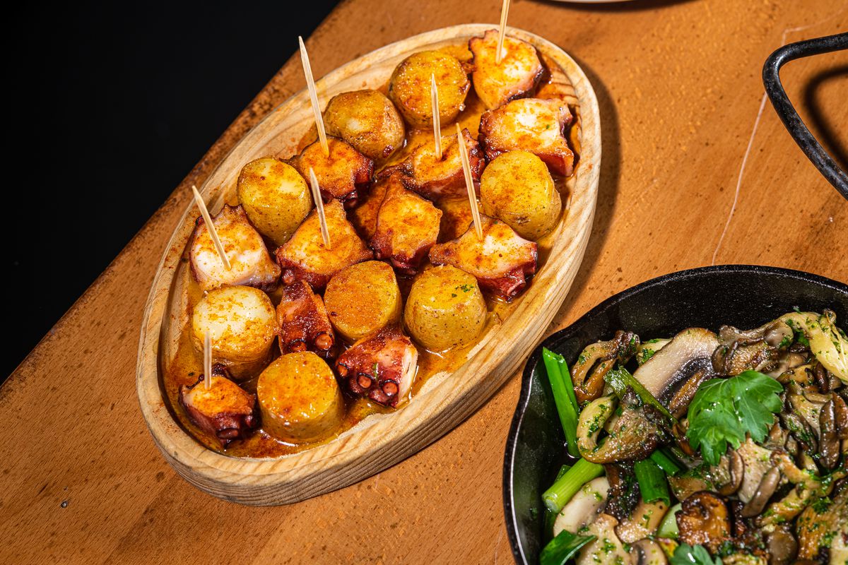 Octopus and potatoes alongside a vegetarian bowl of mixed mushrooms.
