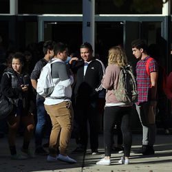 Parents and students gather outside Mountain View High School in Orem on Tuesday, Nov. 15, 2016, after five students were stabbed in an apparent attack by a 16-year-old boy.