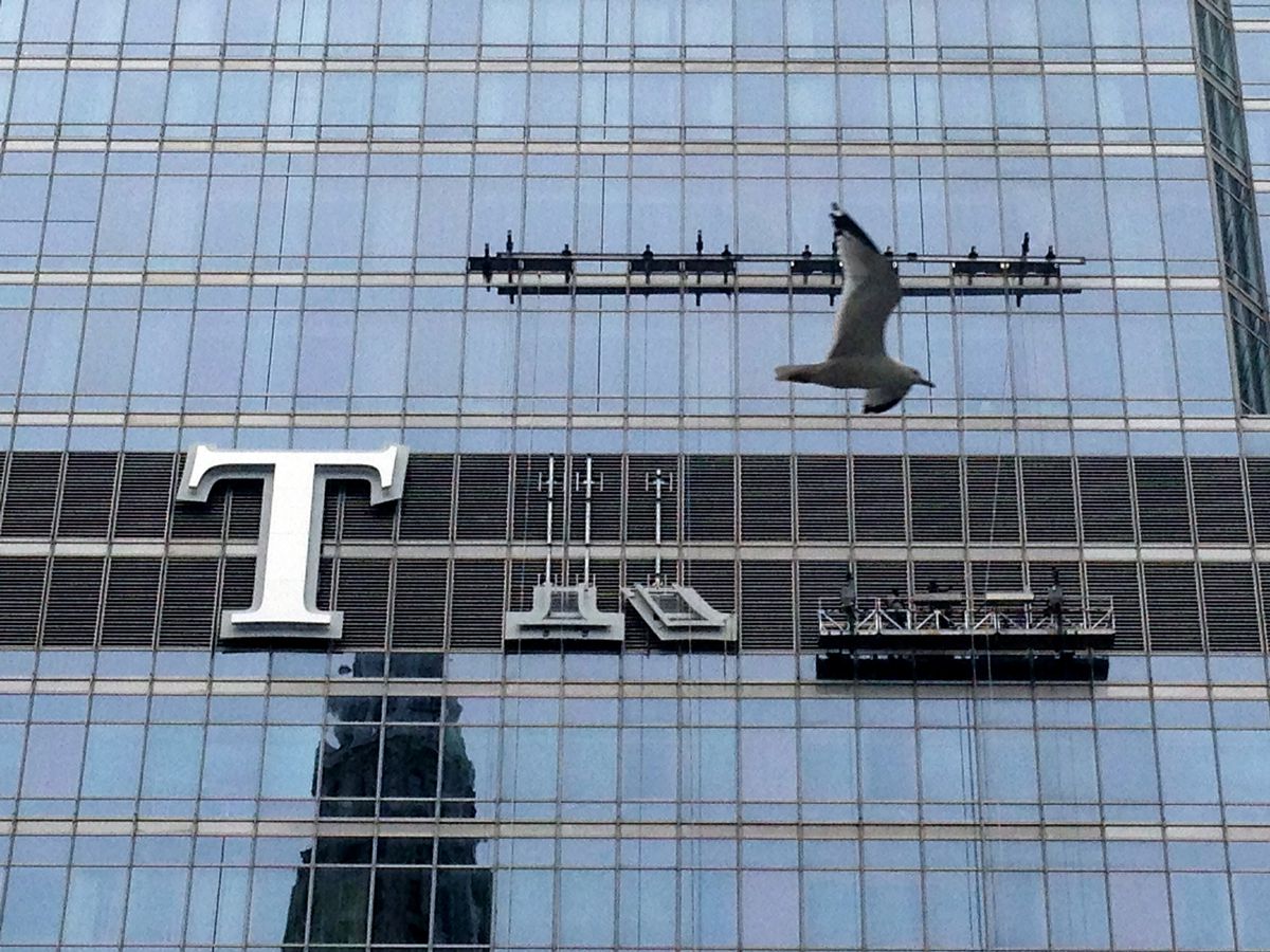 The Trump name being installed on the Trump International Hotel &amp; Tower in May 2014.