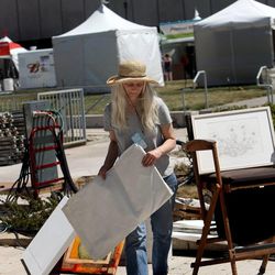 Debbie McNiel of Troy, Mont., sorts through her and her husband's art work while setting up for this weekend's Utah Arts Festival in Salt Lake City on Wednesday, June 19, 2013. The festival runs June 20-23 at Library Square in Salt Lake City.
