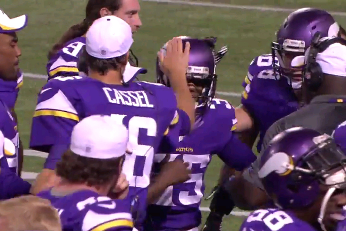 Marcus Sherels was swarmed by teammates shortly after recording his 3rd quarter interception