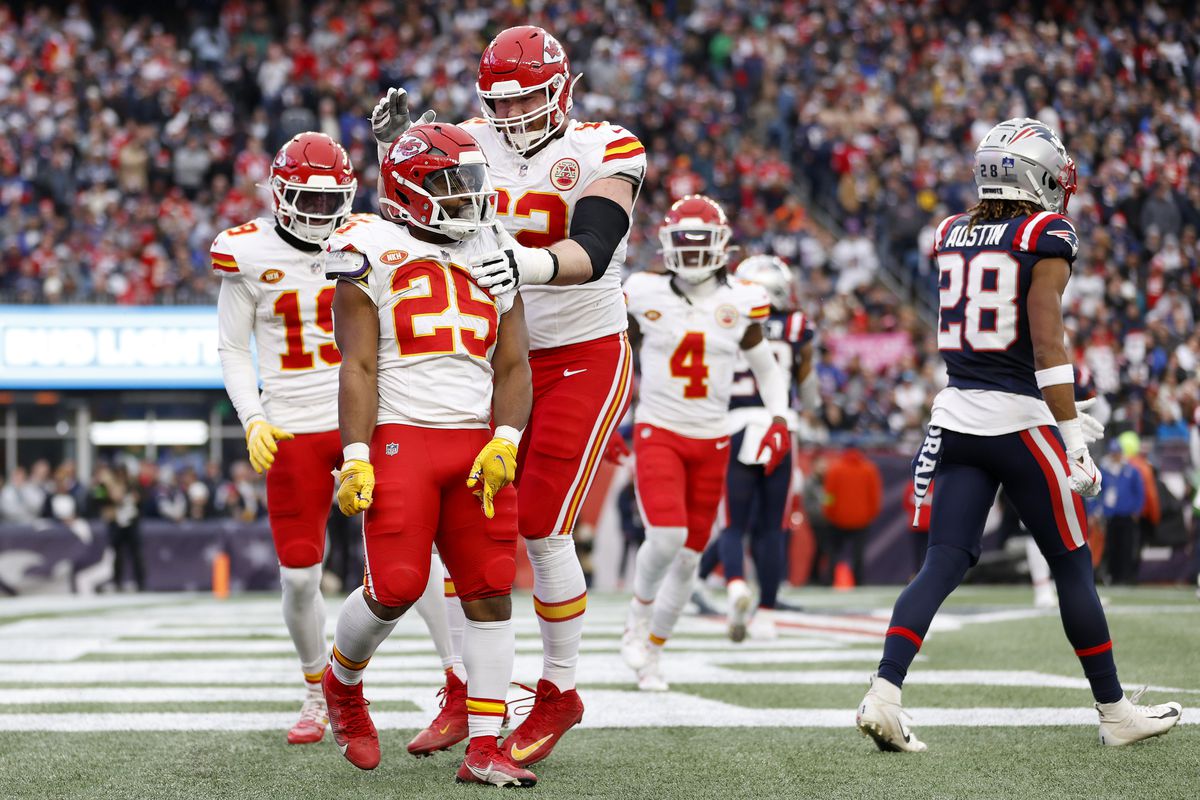 Clyde Edwards-Helaire #25 and Joe Thuney #62 of the Kansas City Chiefs celebrate after Edwards-Helaire’s receiving touchdown during the third quarter against the New England Patriots at Gillette Stadium on December 17, 2023 in Foxborough, Massachusetts.