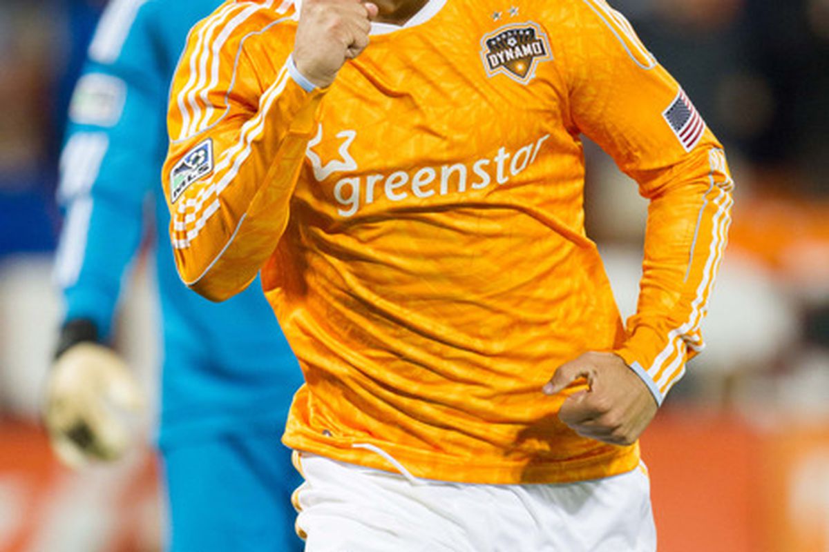 April 28, 2012; Washington, DC, USA; Houston Dynamo forward Will Bruin (12) celebrates after a goal against DC United during the second half at RFK Stadium.  Mandatory Credit: Paul Frederiksen-US PRESSWIRE