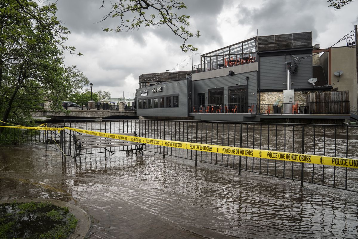 The DuPage River overflowed its banks Monday and flooded portions of the Naperville Riverwalk.