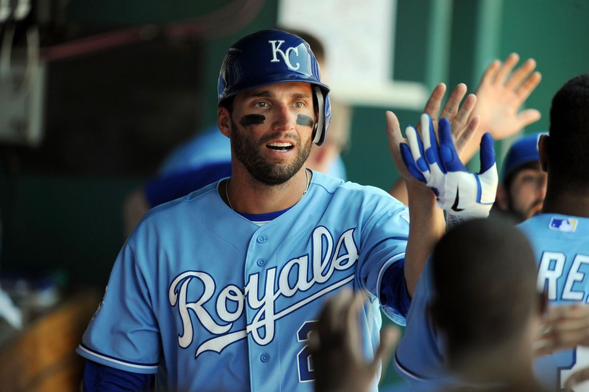 Jun 24, 2012; Kansas City, MO, USA; Kansas City Royals right fielder Jeff Francoeur (21) is congratulated in the dugout after scoring in the sixth inning against the St. Louis Cardinals at Kauffman Stadium. Mandatory Credit: John Rieger-US PRESSWIRE