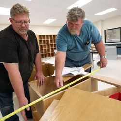 Ray Young and Ken Pickett build a desk in a new lab at Skyline High School in Millcreek on Tuesday, Aug. 15, 2017.