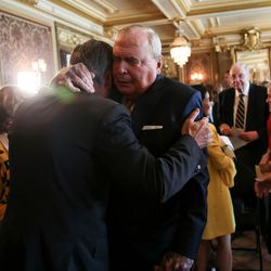 United States Ambassador to Russia Jon M. Huntsman, Jr., left, hugs his father, Jon M. Hunstman, Sr., after a ceremonial swearing-in at the Utah State Capitol in Salt Lake City on Saturday, Oct. 7, 2017. Arizona State won the game, 30-10.