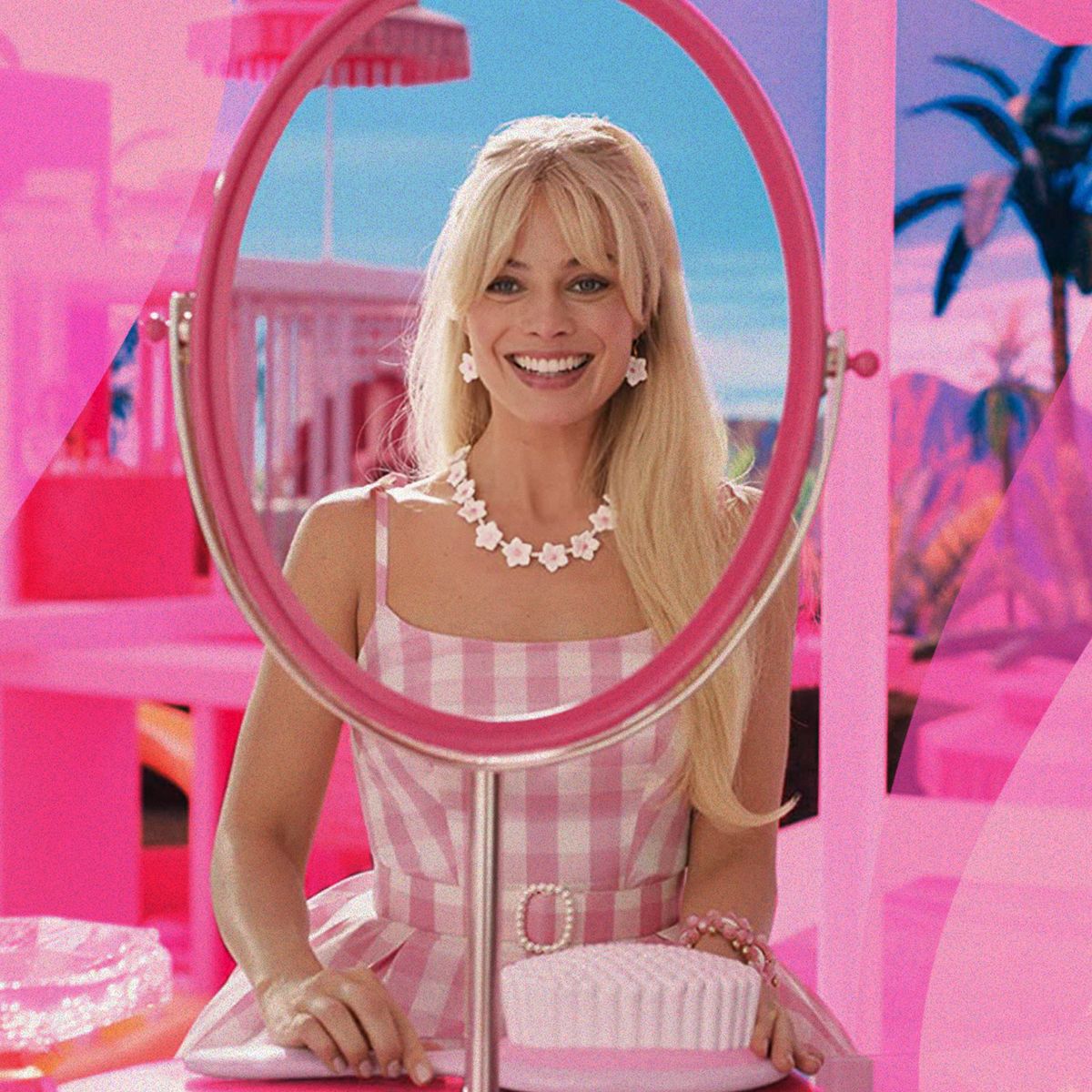 Margot Robbie as Barbie, seen sitting at a pink vanity wearing a pink checked dress and smiling.