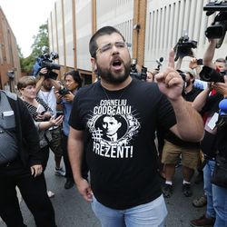 FILE- In this Monday, Aug. 14, 2017, file photo, Matthew Heimbach, center, voices his displeasure at the media after a court hearing for James Alex Fields Jr., in front of court in Charlottesville, Va. A judge has denied bond for Fields accused of plowing his car into a crowd at a white nationalist rally.