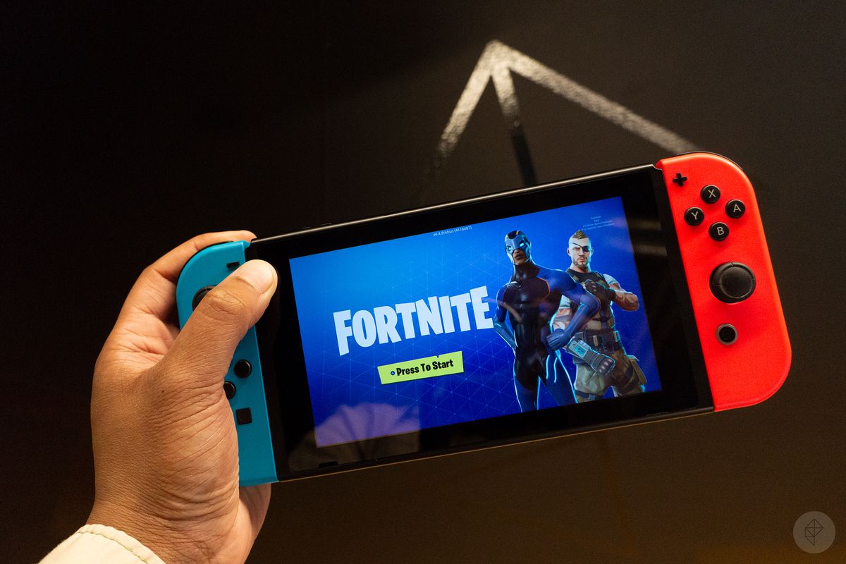 Fortnite running on a Nintendo Switch being held by a left hand