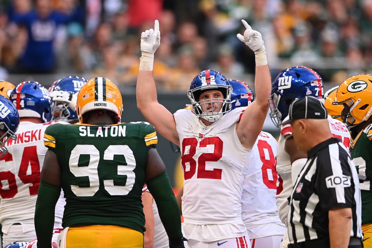 Daniel Bellinger #82 celebrates a 2 yard touchdown by Gary Brightwell #23 of the New York Giants (not pictured) in the fourth quarter during the NFL match between New York Giants and Green Bay Packers at Tottenham Hotspur Stadium on October 09, 2022 in London, England.