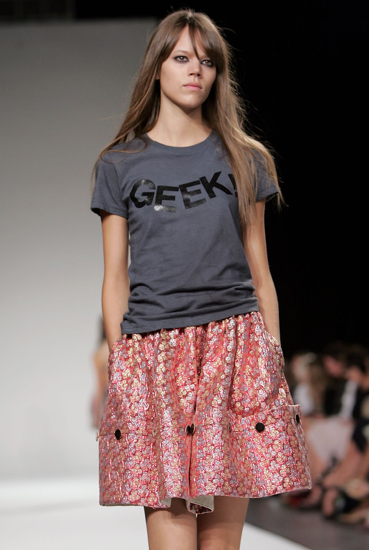 A model wears a “Geek!” shirt on the runway.