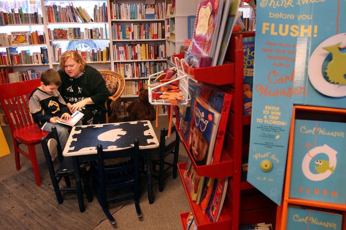 Finn Werner, 5, and his mother, Tamara, of Clearfield, read a book in The King's English bookstore in Salt Lake City in 2005. Amazon is attempting to get independent booksellers to carry the Kindle.