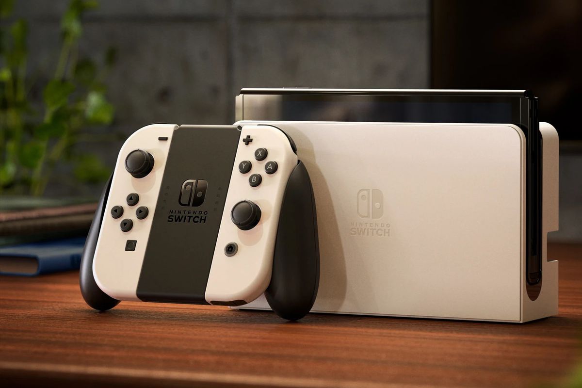A photo of the new Nintendo Switch (OLED model) in white on a wooden table