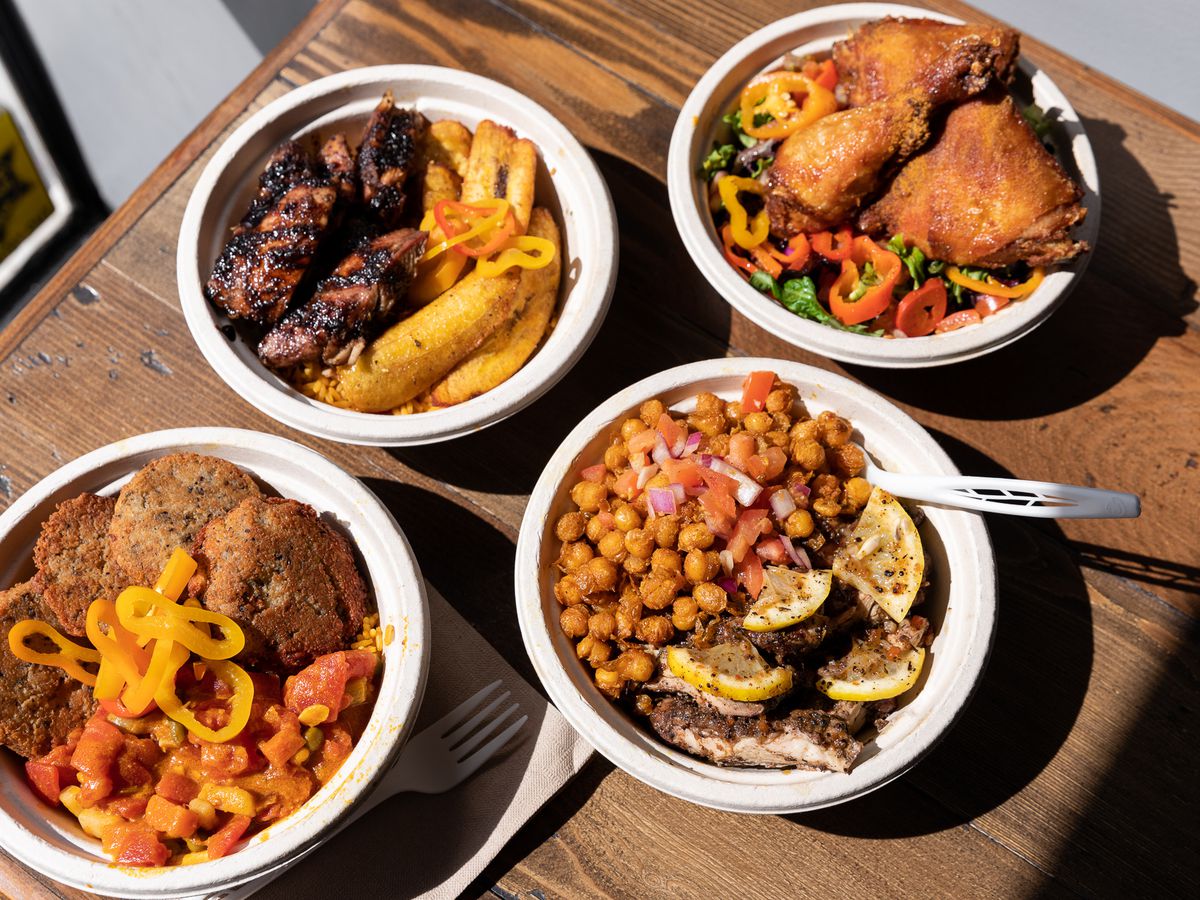 Bowls of Afro-Caribbean food including jerk chicken, fried ginger chickpeas, and suya fried chicken at Yum Village.