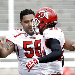 LT Tuipulotu (58) and Mo Talley celibate the white team's win after the Red-White game at Rice-Eccles Stadium at the University of Utah in Salt Lake City on Saturday, April 20, 2013.