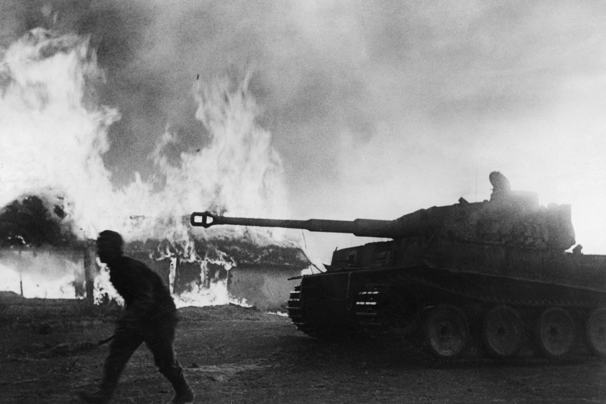 2. WW, campaign against soviet union: War theater: battle of Kursk - tanks (Tiger I) and infabntry entering a burning village. August 1943