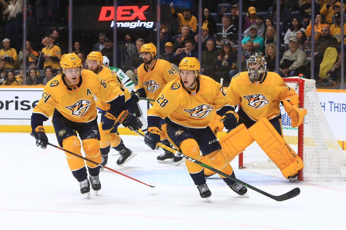 Nashville Predators right wing Mikael Granlund, of Finland, and right wing Eeli Tolvanen, of Finland, are shown during the NHL game between the Nashville Predators and Dallas Stars, held on March 8, 2022, at Bridgestone Arena in Nashville, Tennessee.