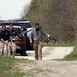 McHenry County Sheriff’s officers and other law enforcement search with a drone the area of Route 176 and Dean Street south of Woodstock, Wednesday morning. This is related to the missing Crystal Lake boy. | Brian Hill/Daily Herald