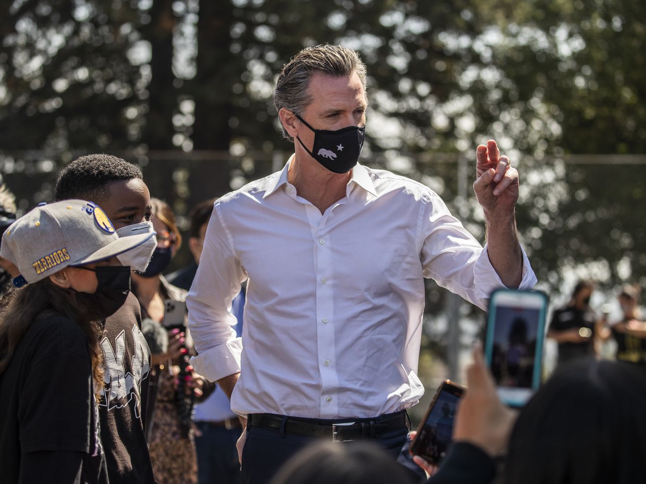 California Gov. Gavin Newsom gestures while speaking to a crowd of students outdoors in Oakland, California, on September 15, 2021.