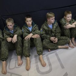 In this photo taken on Friday, Oct. 28, 2016, Russian children listen to a trainer during a practice in parachute techniques in Verkhnyaya Pyshma, just outside Yekaterinburg, Russia. The training has been run by Yunarmia (Young Army), an organization sponsored by the Russian military that aims to encourage patriotism among the Russian youth. 