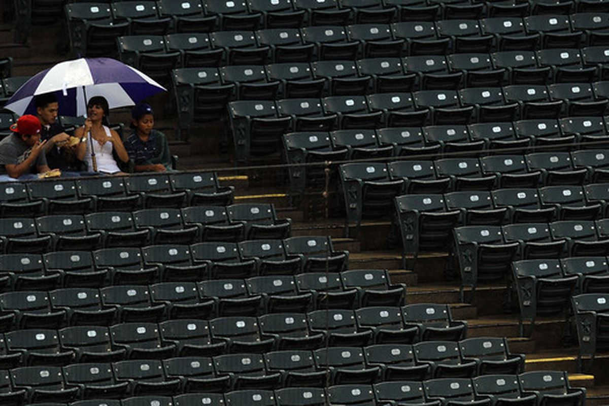 ARLINGTON TX - JULY 09:  Fans wait during a rain delay before a game between the Baltimore Orioles and the Texas Rangers on July 9 2010 at Rangers Ballpark in Arlington Texas.  (Photo by Ronald Martinez/Getty Images)