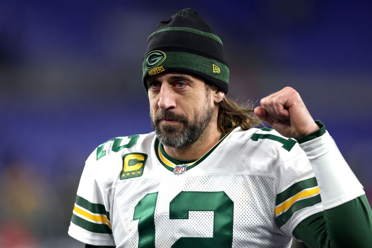 Aaron Rodgers #12 of the Green Bay Packers celebrates as he walks off the field after their game against the Baltimore Ravens at M&amp;T Bank Stadium on December 19, 2021 in Baltimore, Maryland.