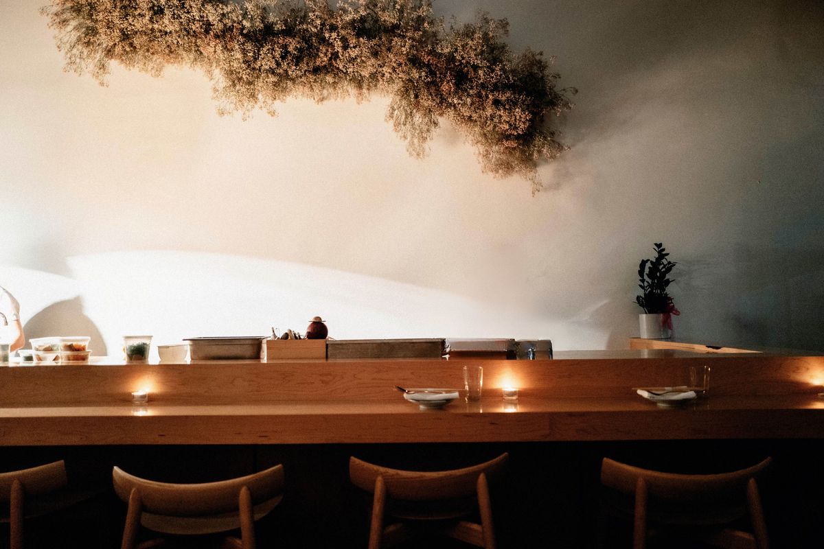 Dimly lit wooden counter for a modern Korean restaurant in LA.