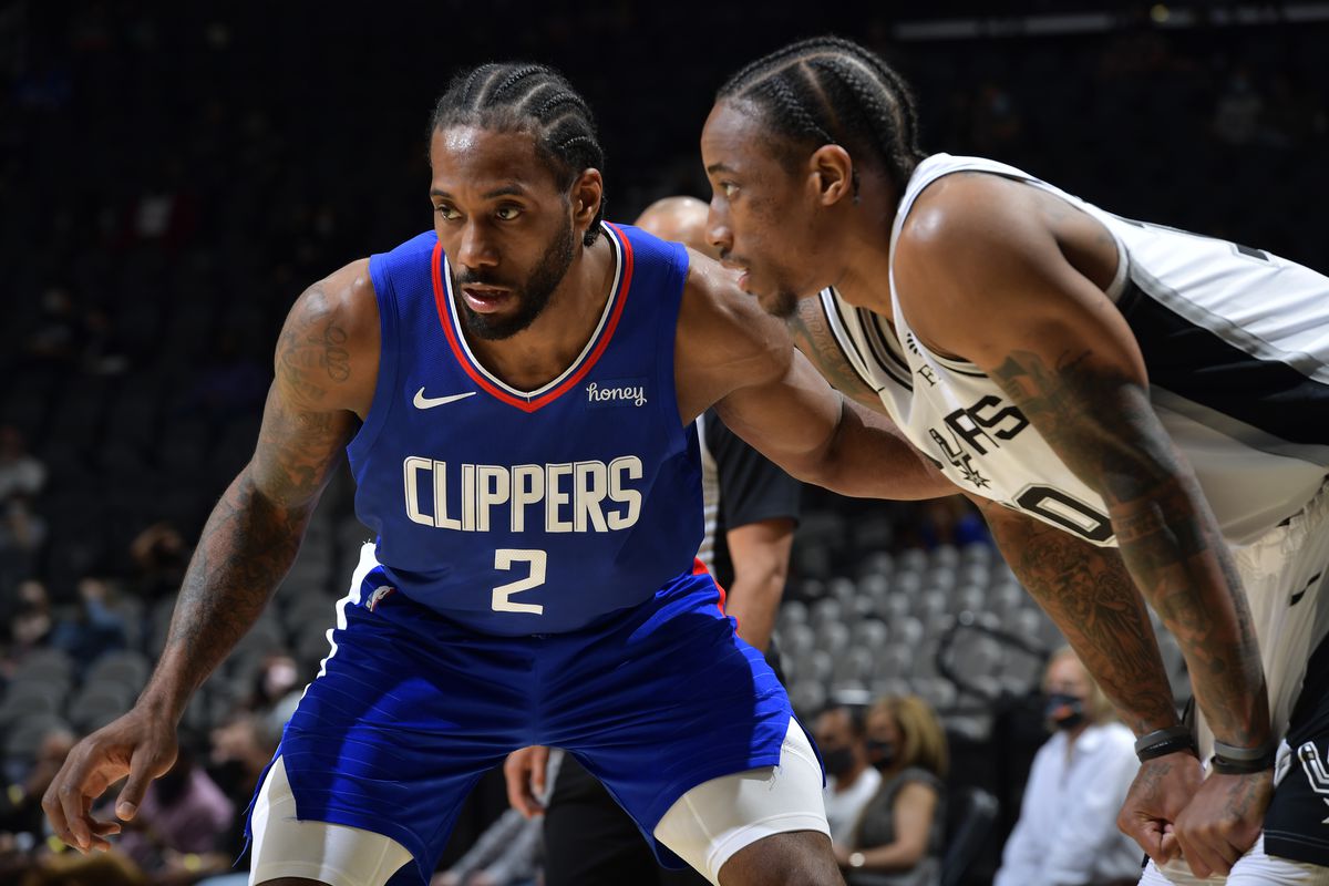 Kawhi Leonard of the LA Clippers and DeMar DeRozan of the San Antonio Spurs fights for position during the game on March 24, 2021 at the AT&amp;T Center in San Antonio, Texas.