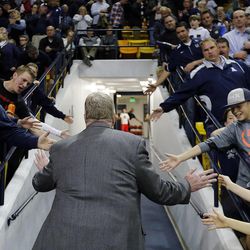 Head coach Stew Morrill of Utah State is greeted by fans as he leaves the court following NCAA basketball against UNLV in Logan Tuesday, Feb. 24, 2015.


