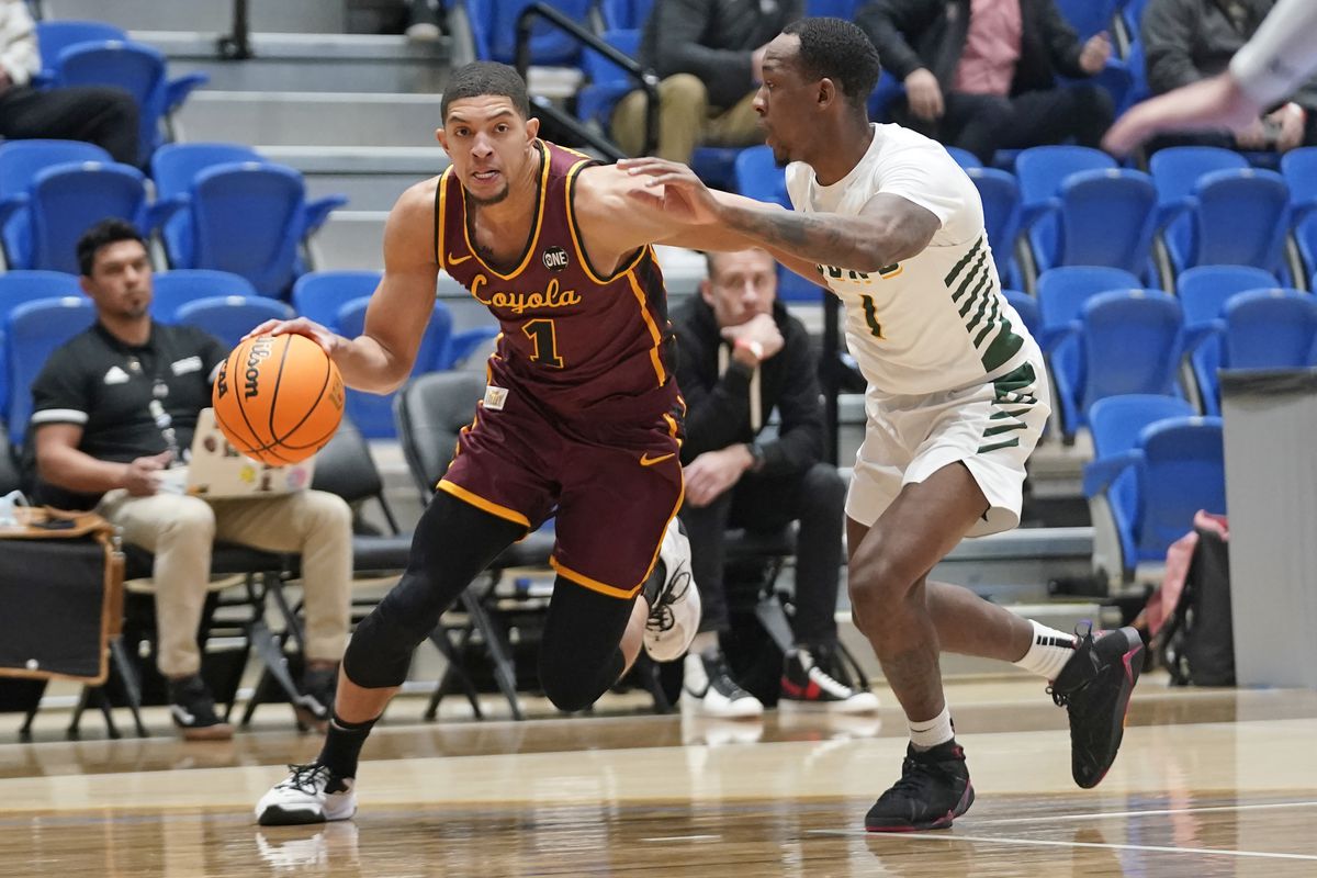 Loyola guard Lucas Williamson (1) drives as San Francisco guard Jamaree Bouyea (1) defends in the first half of Thursday’s game in Taylorsville, Utah. 
