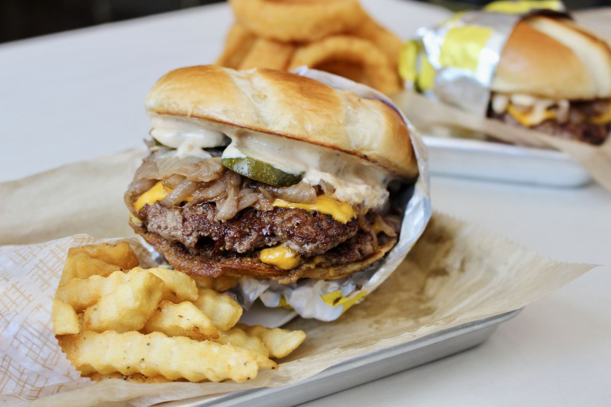 A smash burger and pile of fries.