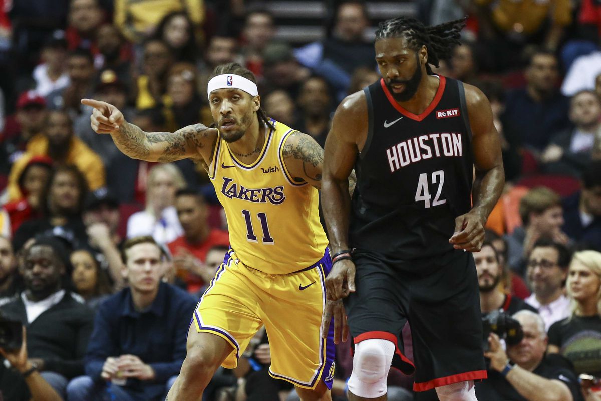 Los Angeles Lakers forward Michael Beasley and Houston Rockets center Nene Hilario react after Beasley scores a basket during the second quarter at Toyota Center.