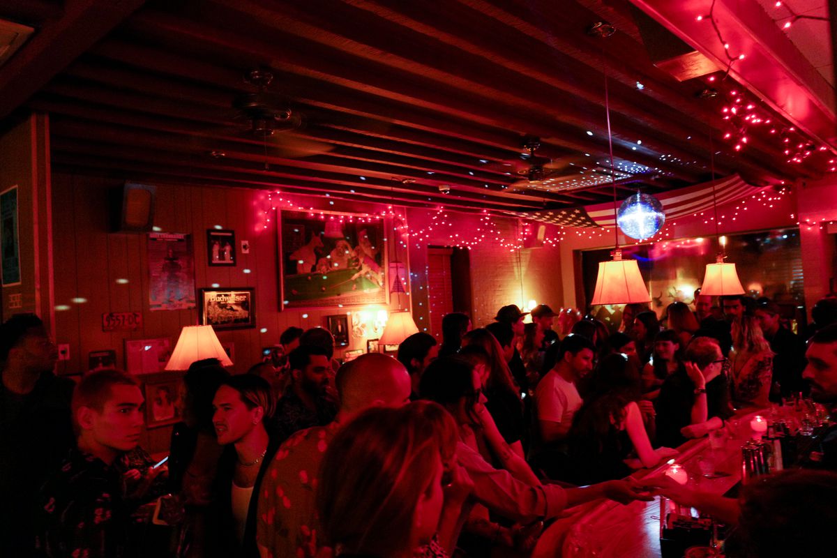A red-lit crowded bar.
