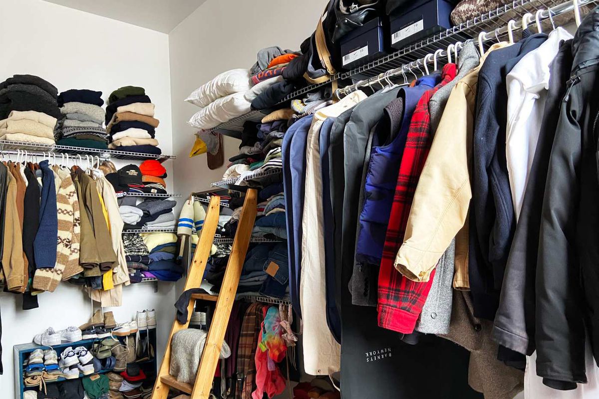 Closet lined with a wall of clothes. 