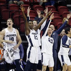 Utah State players cheer as a teammate hits a three point shot against the Colorado State Rams during the Mountain West Conference basketball tournament in Las Vegas on Wednesday, March 7, 2018.